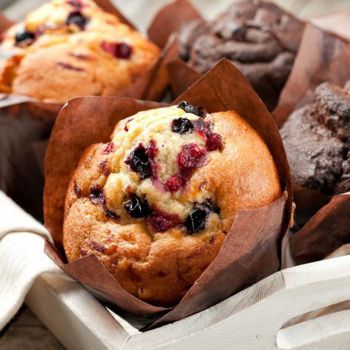 blueberry and chocolate muffins in paper cupcake holder